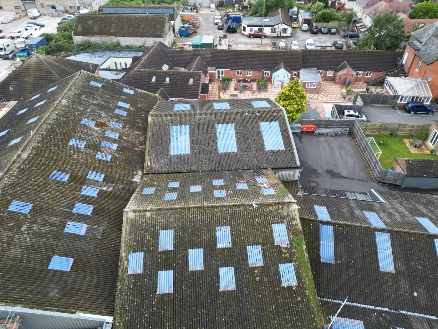 Ageing asbestos cement roofs with roof lights, seen from above
