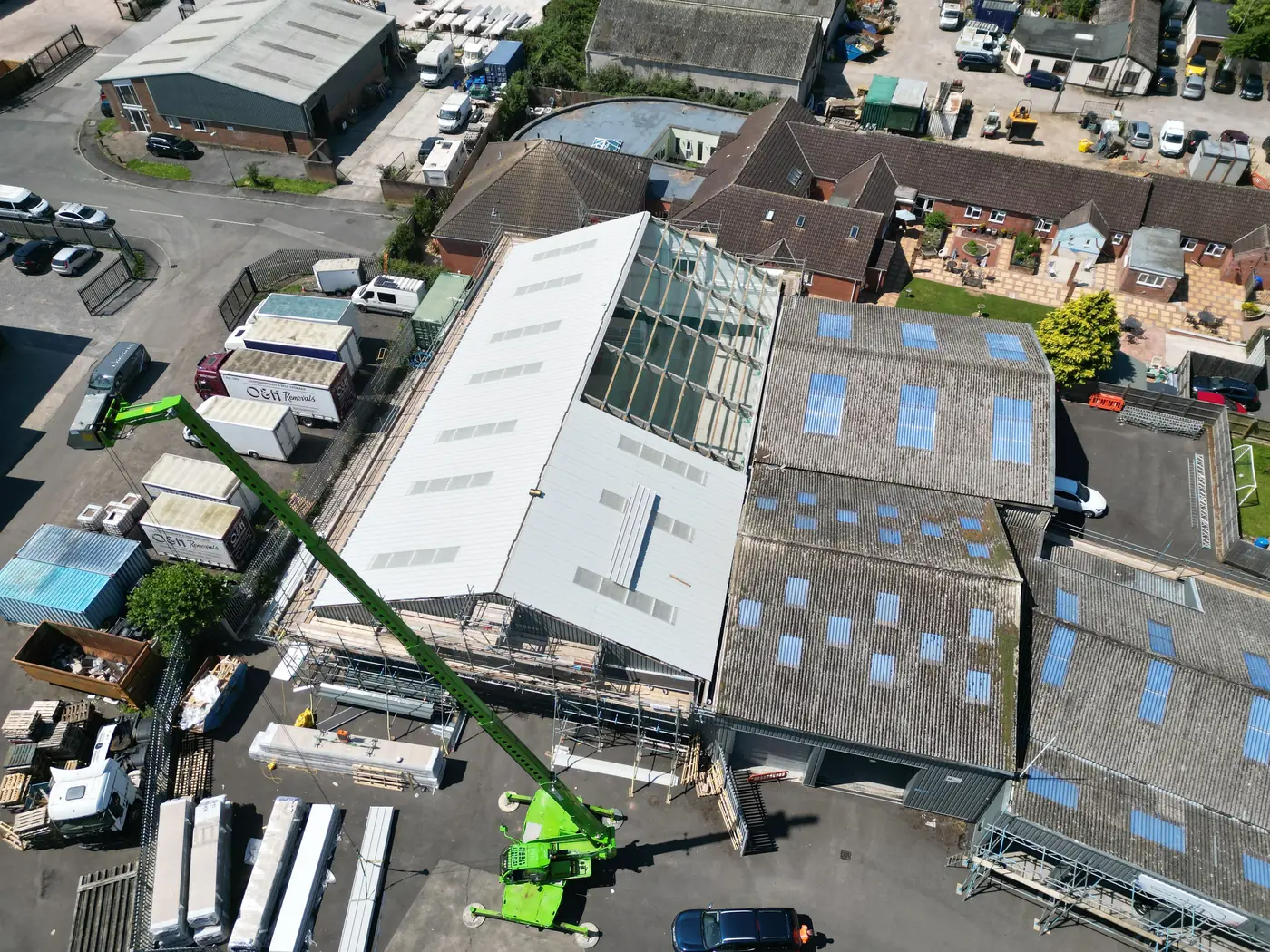 New panels being installed beside the old roof