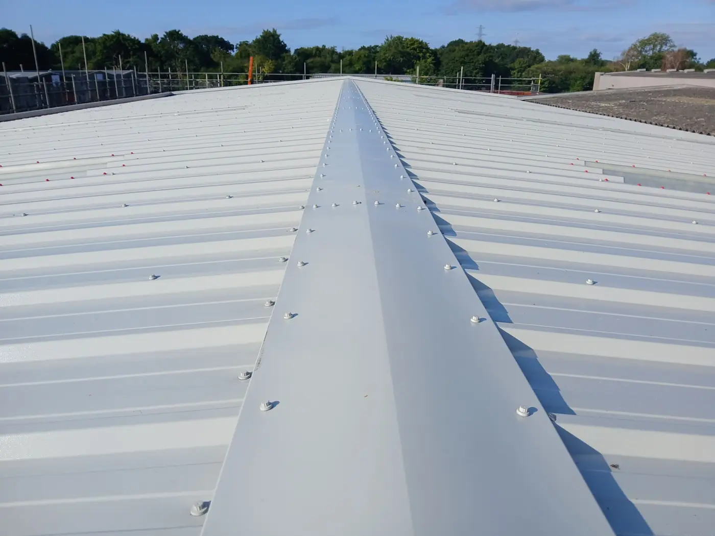 New ridge flashing along the composite roof