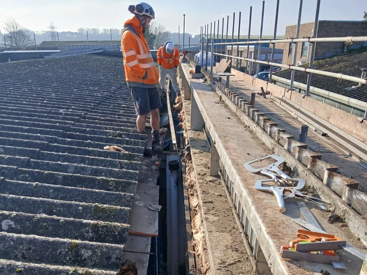 Our team working along the gutter of an asbestos cement roof