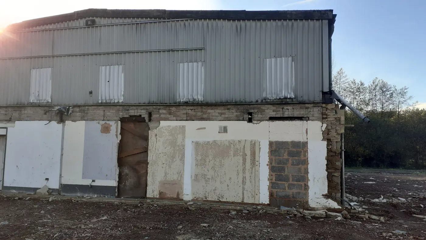 Uneven blockwork and patched elevation before refurbishment